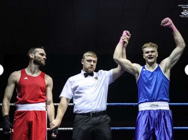 A referee raising the arm of the club's boxer after another bout